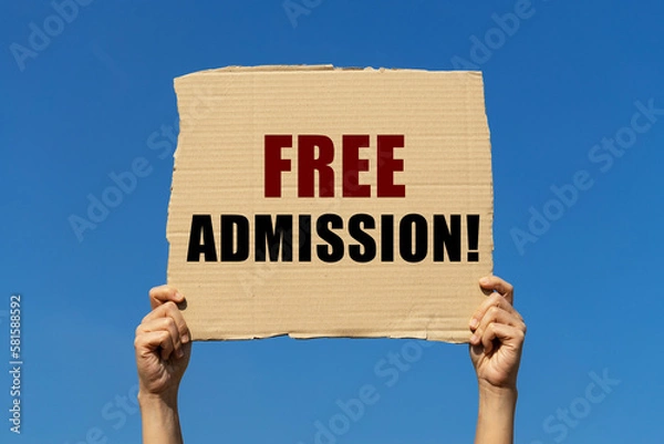 Fototapeta Free admission text on box paper held by 2 hands with isolated blue sky background. This message board can be used as business concept about Free admission.