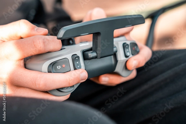 Fototapeta person using a remote control for a dji drone