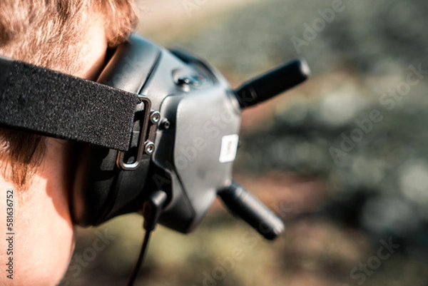 Fototapeta close up of a person using the fpv goggles for a dji drone