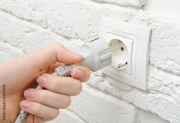 Fototapeta plug the wire into the socket