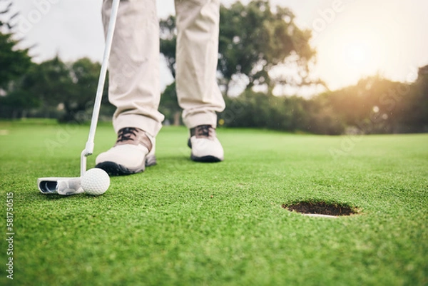 Fototapeta Golf, closeup and golfer or player hit ball and professional athlete training and putting on a filed as exercise or workout. Feet, equipment and gentleman or person relax and playing a sport