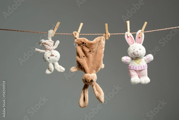 Fototapeta Plush bunnies on the clothesline,on  gray  background