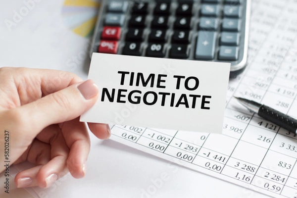 Fototapeta time to negotiate the text on the card is in the hand of a man in white clothes.