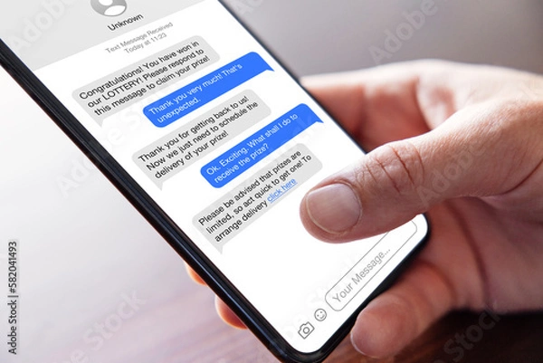 Fototapeta Person reading scam messages on mobile phone