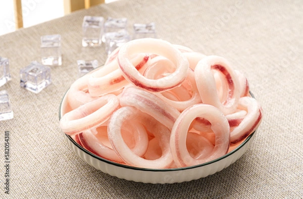 Fototapeta Frozen squid rings on a simple background