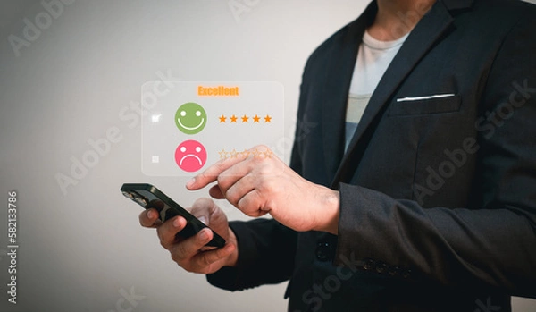 Fototapeta customer evaluation and survey, businessman using phone tick on smile face because he is satisfied with excellent service and performance