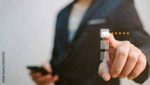 Fototapeta customer satisfaction evaluation concept, businessman hold mobile phone and evaluate for excellent quality of the service so he ranking at five star