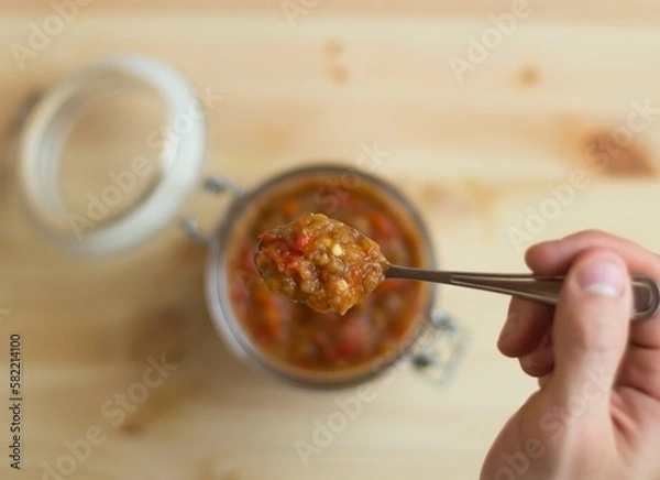 Obraz Vegetable squash sauce in a glass jar on a wooden background.
