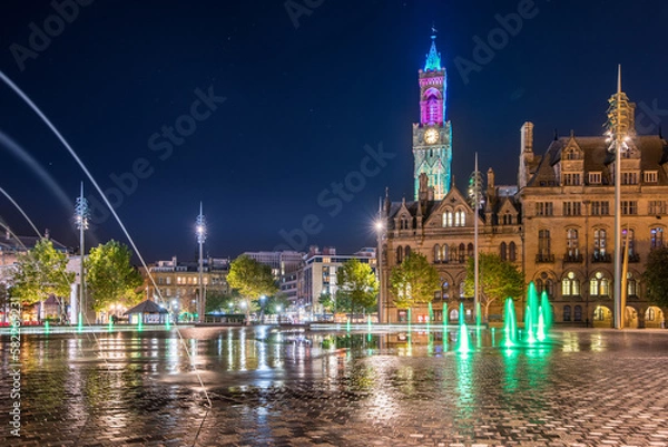 Fototapeta Night view of illuminated clock tower and fountain at  Centenary Square Bradford UK