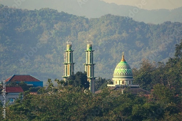 Obraz a mosque looks top surrounded by hills that are green and fresh