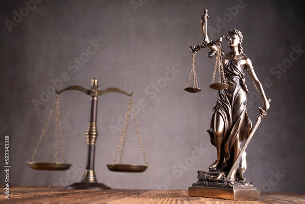 Fototapeta Law and justice concept. War crimes. Gavel, scale and Themis sculpture in lawyers office. Gray background.