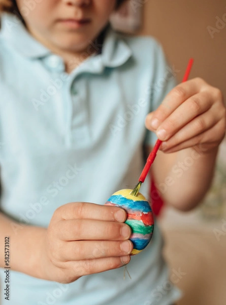 Fototapeta Boy painting Easter eggs