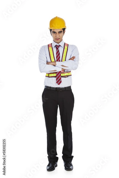 Fototapeta Male architect standing with his arms crossed