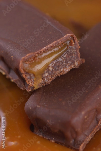 Obraz Sweet bar with caramel filling in caramel