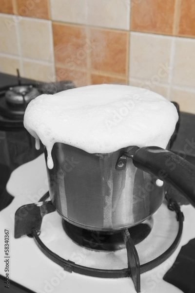 Obraz Milk boiling over a pan