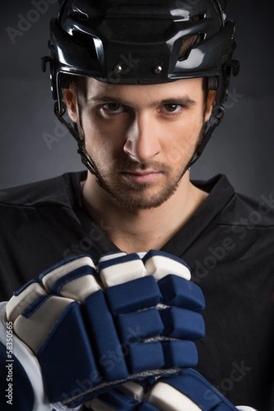 Fototapeta Portrait of handsome hockey player in black helmet.