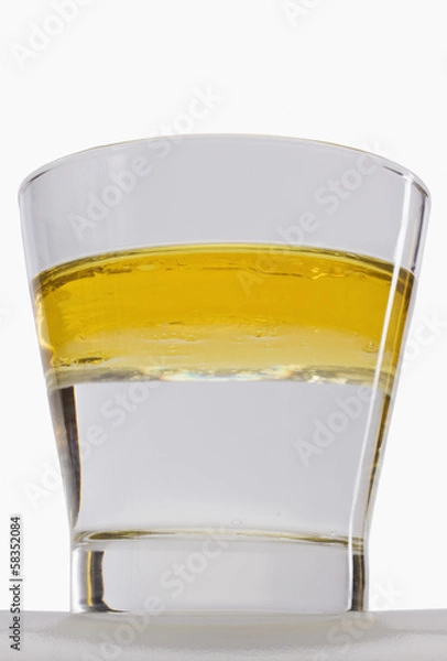 Obraz Oil floating on water surface in a glass