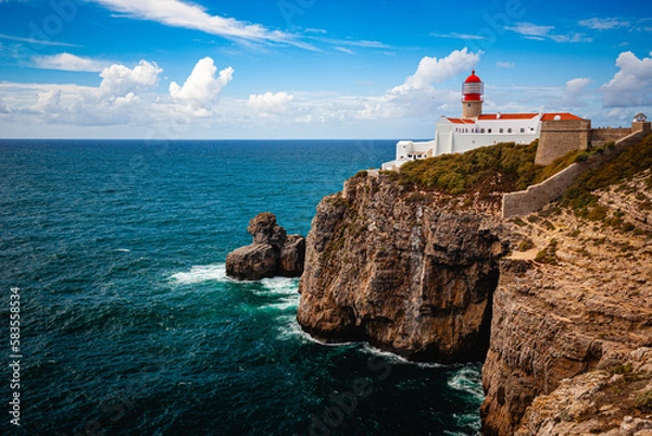 Fototapeta white lighthouse on cliffs at algarve portugal