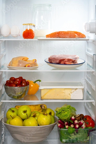 Obraz Refrigerator with healthy food. Refrigerator with meat, fish, chicken, red caviar, steaks, vegetables, fruits, eggs. Fridge full of healthy food only. Diet with protein. Refrigerator with protein diet