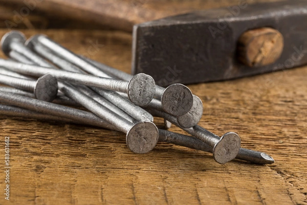 Fototapeta Vintage hammer with nails on wood background