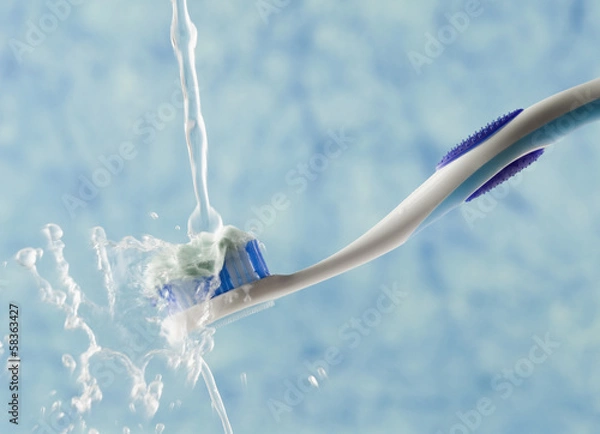 Obraz Water being poured on a toothbrush