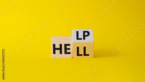 Fototapeta Help vs Hell symbol. Turned wooden cubes with words Hell and Help. Beautiful yellow background. Psychology and Help vs Hell concept. Copy space