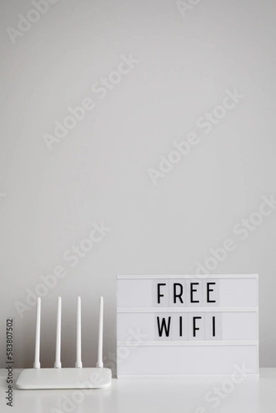 Fototapeta White router and lightbox with free wifi text