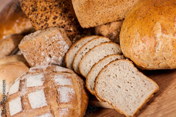 Fototapeta Group of different bread's type on wooden table
