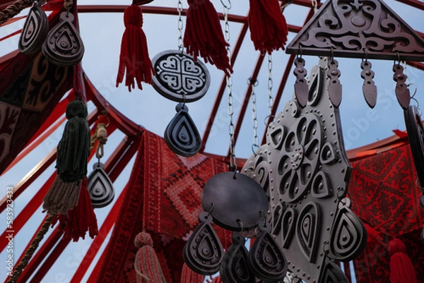 Fototapeta Decoration elements of asian holiday Nauryz are swaying in the wind