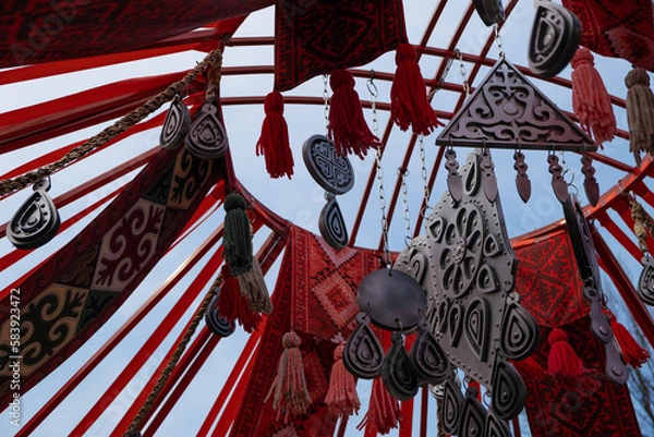 Fototapeta Decoration elements of asian holiday Nauryz are swaying in the wind
