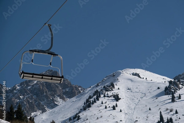 Fototapeta Empty cableway cabin under mountains