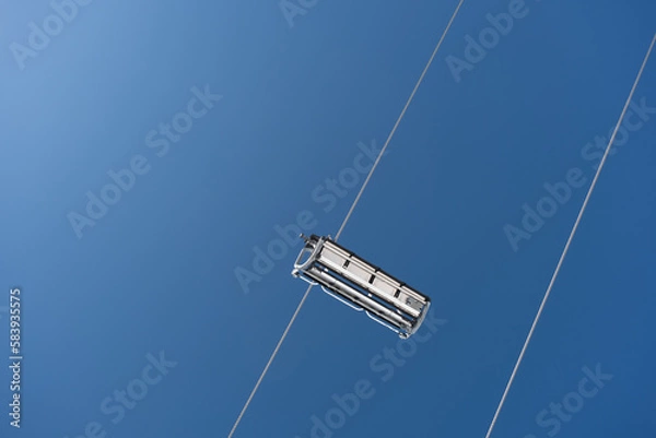 Fototapeta Vertical shot of empty cableway cabin