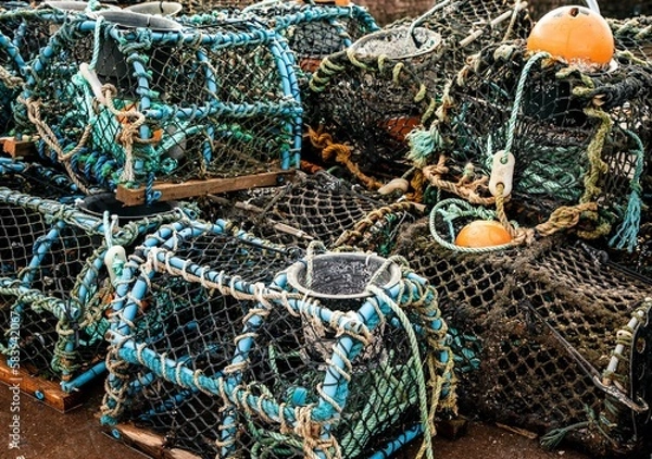 Fototapeta Selective focus shot of fishermen's lobster pots on a pile drying on a harbor