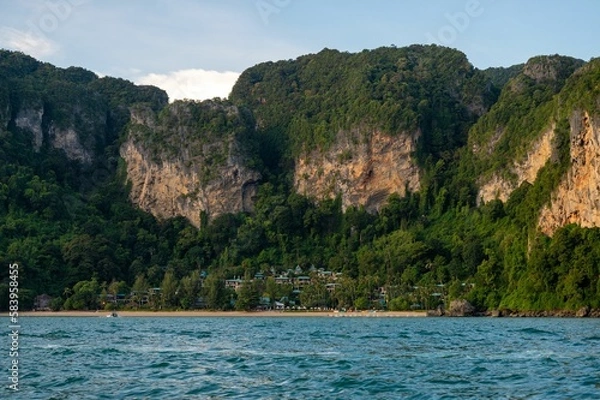 Fototapeta Beach with large cliffs and greenery