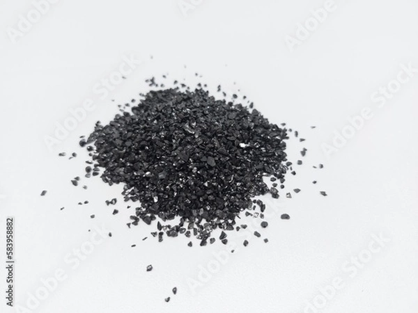 Fototapeta Anthracite commonly used in the water filtration to remove impurities and improve water quality. Anthracite known as hard black coal is acompact variety of coal. Isolated on white background