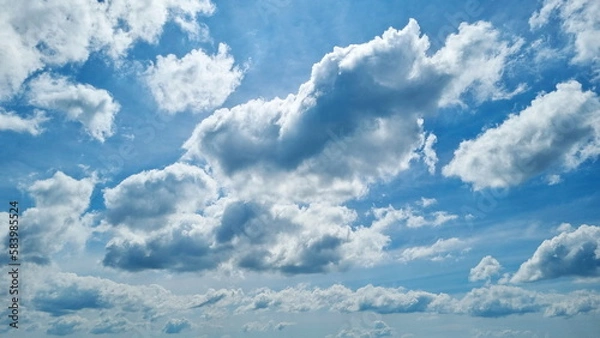 Obraz White cloudy swimming under blue sky.