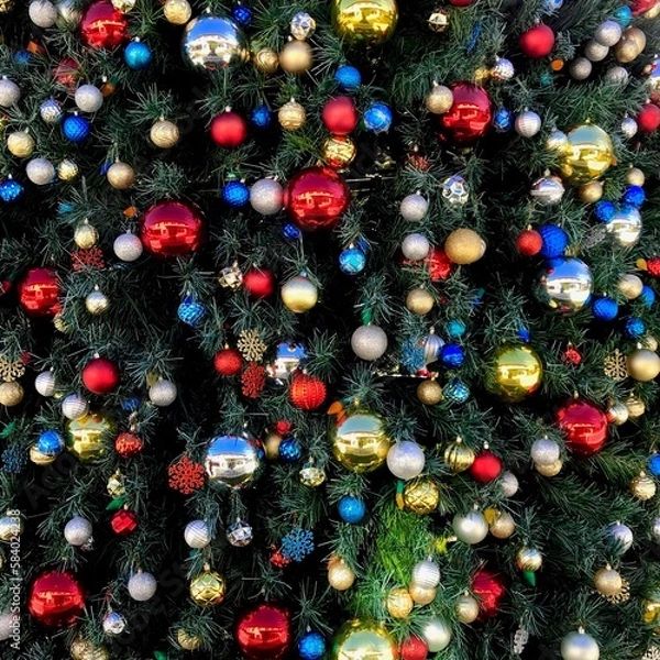 Fototapeta Christmas decorations on a large tree close up background