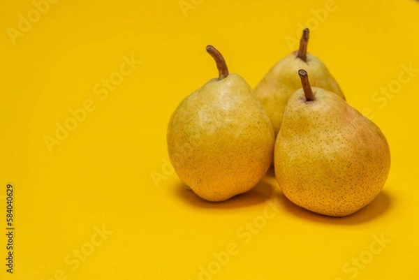 Fototapeta Organic Pear on a yellow. Juicy fruit, cool minimal copy space.