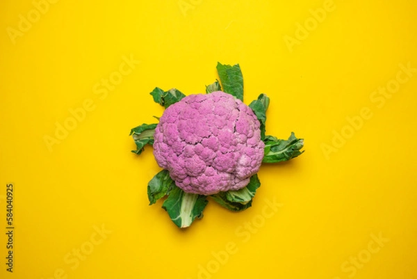 Fototapeta Pink cauliflower on a yellow background. Cool minimal flat lay, copy space.