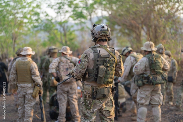 Obraz Team of U.S. Army marine corps soldier military war with gun weapon participating and preparing to attack the enemy in Thailand during exercise Cobra Gold training in battle. Combat force.