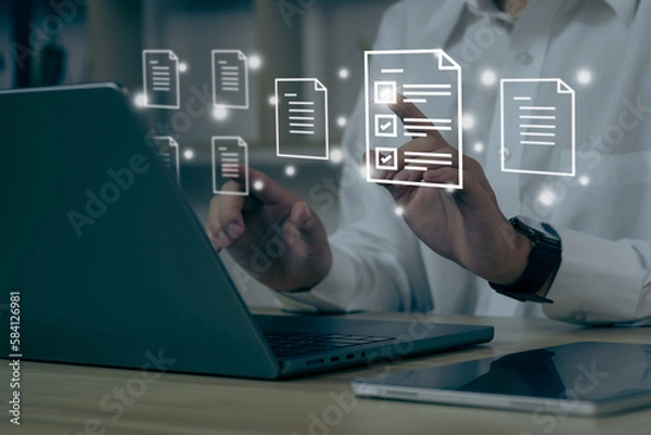 Obraz Businessman using a computer to document management concept, online documentation database and digital file storage system/software, records keeping, database technology, file access, doc sharing..