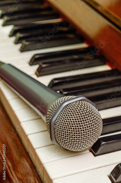 Fototapeta Microphone on keyboard of piano