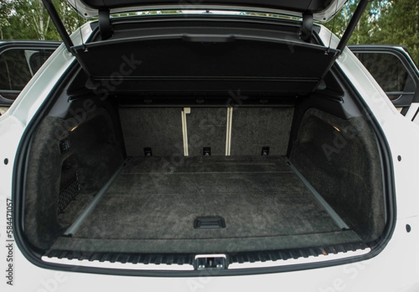 Fototapeta Huge, clean and empty car trunk in interior of compact suv. Rear view of a SUV car with open trunk
