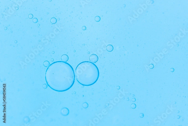 Fototapeta Air bubbles in the water background.Abstract oxygen bubbles in the sea.Water bubbles isolate on blue background.Air bubble floating up to top of water surface which little and big circle shape.