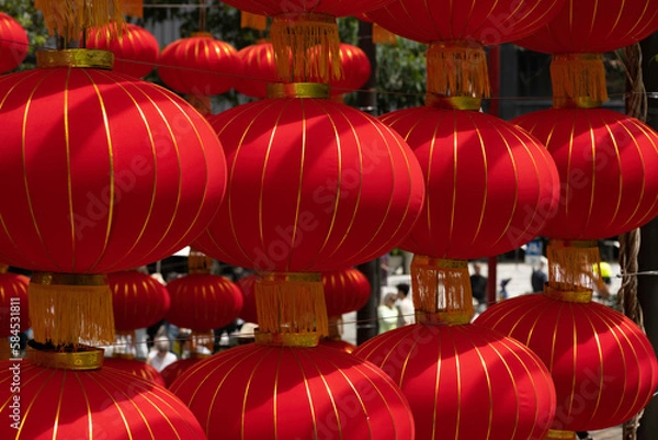 Fototapeta Close up of bright, red Chinese lanterns with gold stripes to celebrate Lunar New Year.