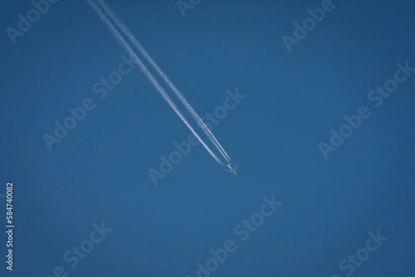 Fototapeta High altitude flight with contrails  