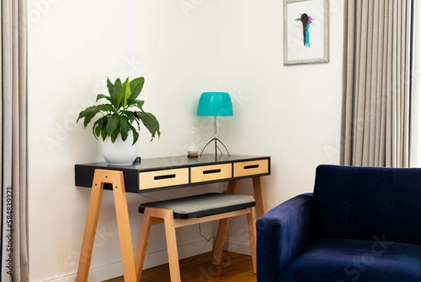 Fototapeta Corner of living room interior with armchair, plant and lamp on table, curtains and painting on wall