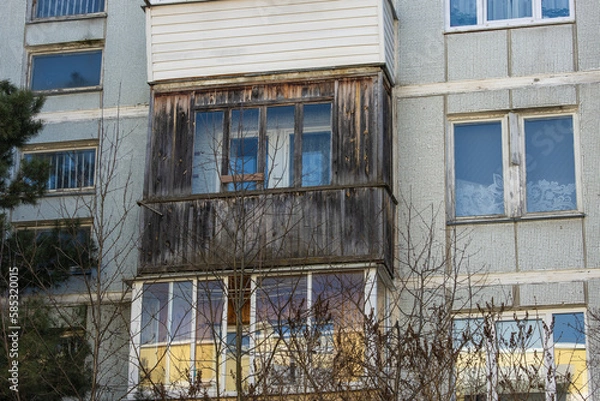 Fototapeta Close-up of an old dilapidated balcony lined with wood in an old soviet apartment building