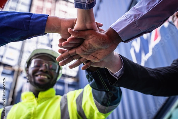 Fototapeta Engineer manager and foreman team joining hands, Workers Join Hand for Collaboration in the container yard.