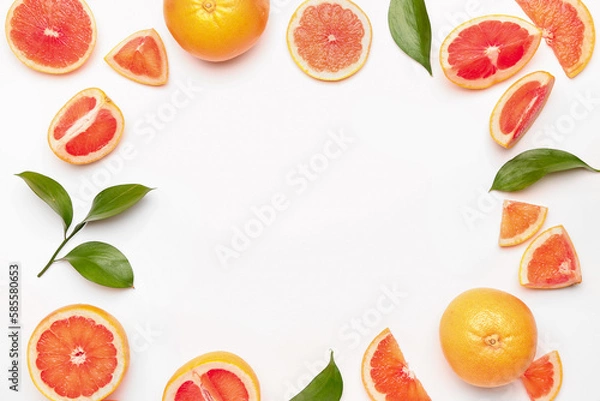 Obraz Frame made of juicy grapefruit pieces and plant leaves on white background, closeup